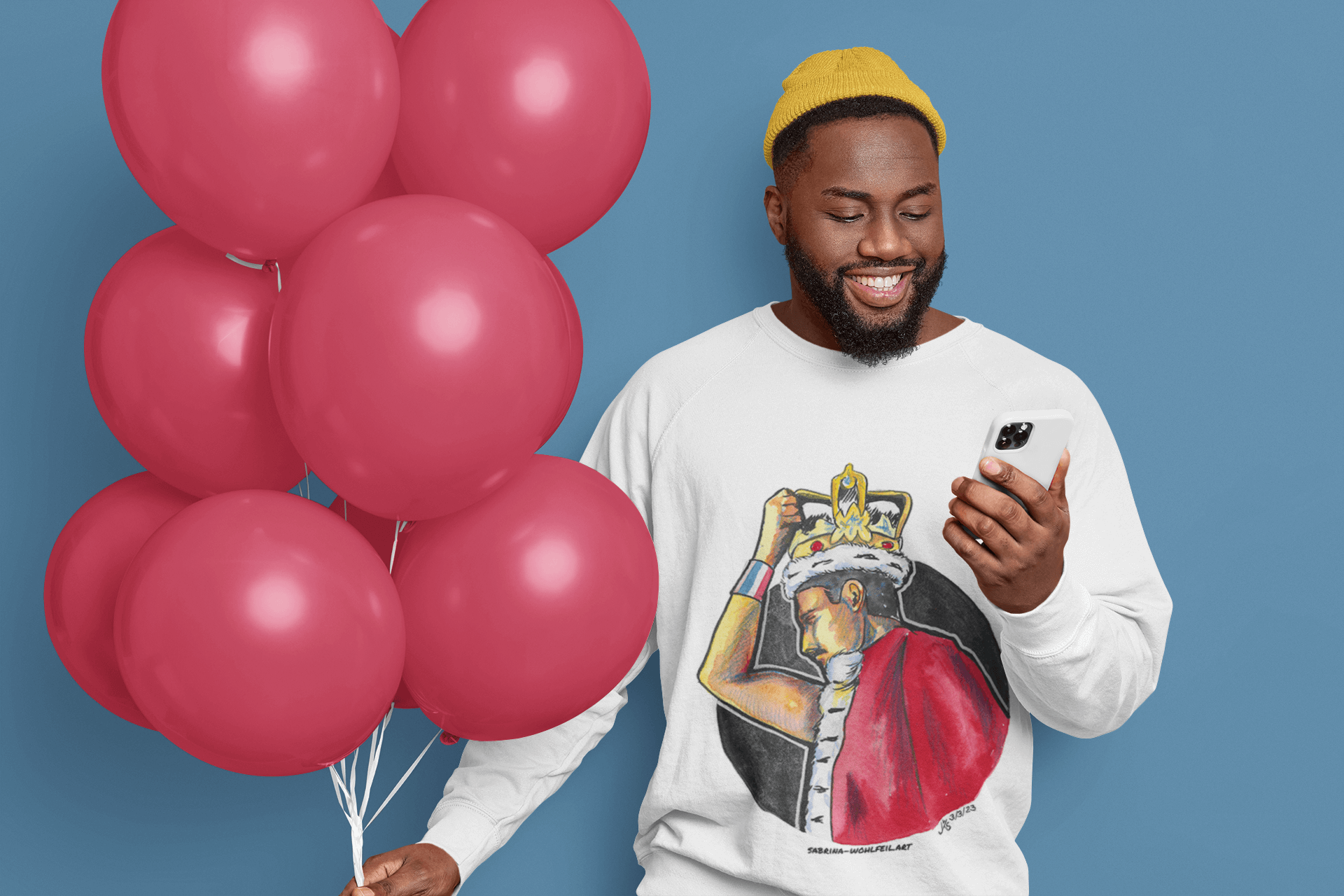 Man wearing Freddie Mercury Aquarell Print Comic Sketch Unisex Sweatshirt with round neckline holding red balloons and phone